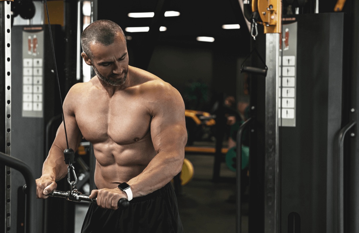A lifter doing a tricep pushdown on a cable machine